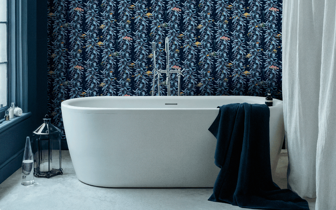 Bathroom with luxury ocean wallpaper featuring sea kelp fish design in sea blue behind a modern white freestanding bathtub